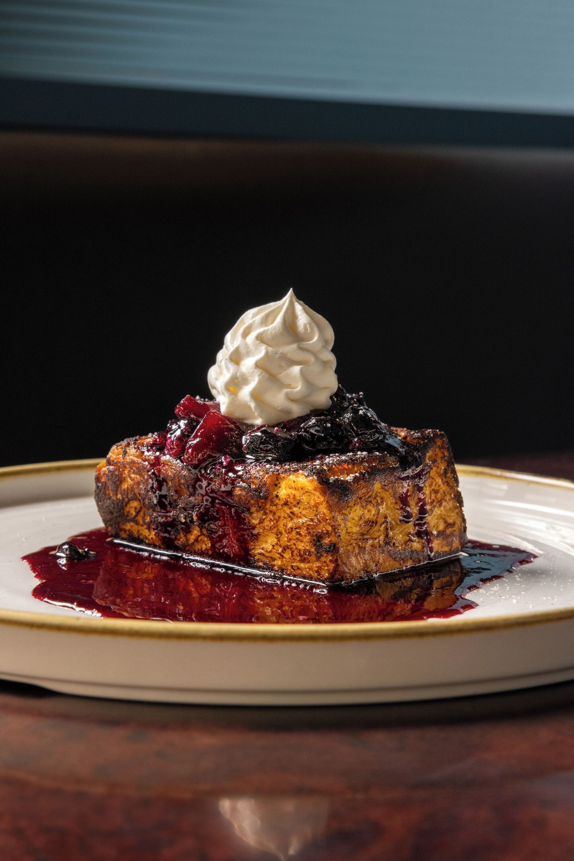 A dessert on a plate with a dark background.