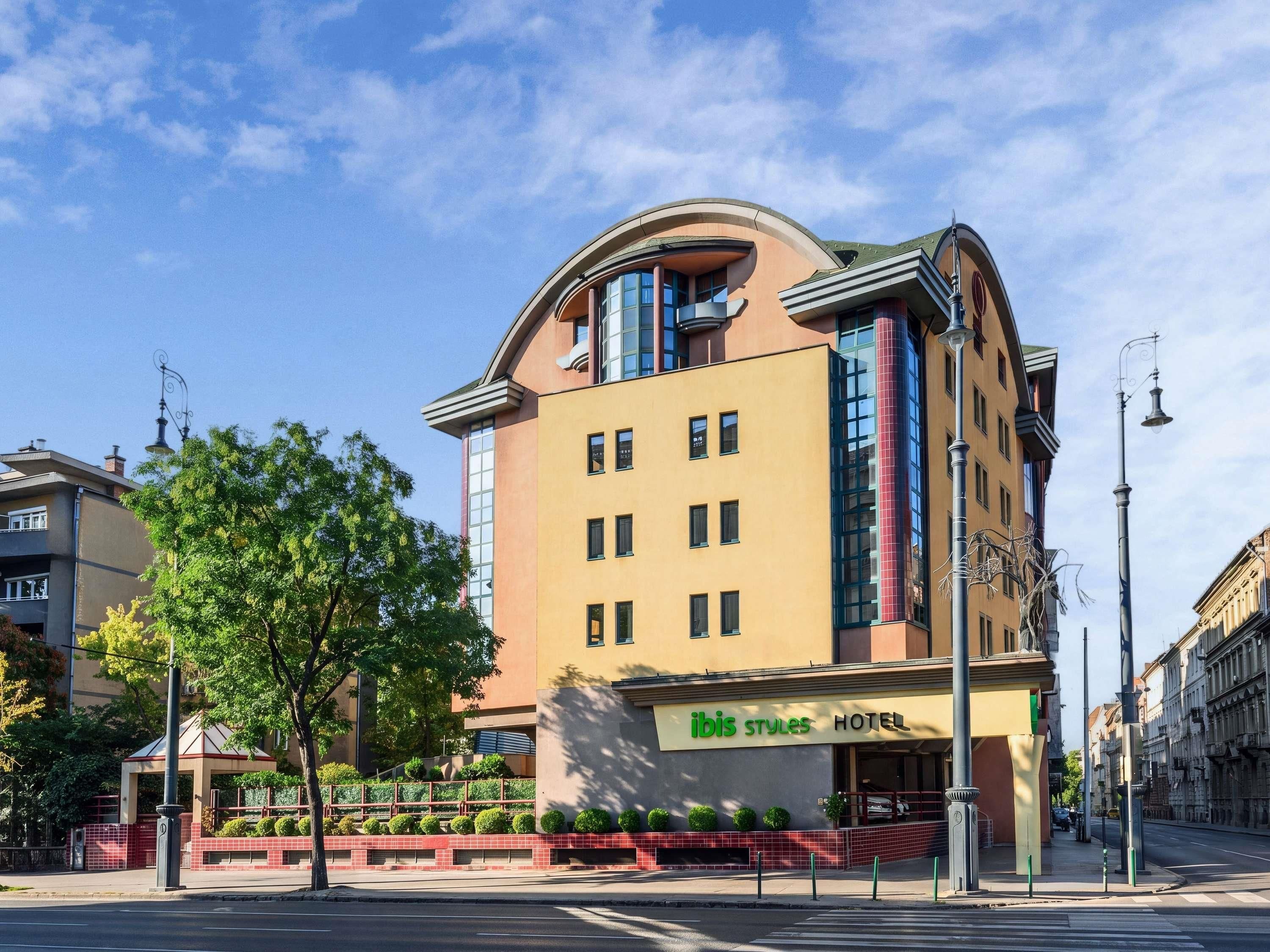 A hotel with a modern design, featuring a curved facade and a prominent entrance.
