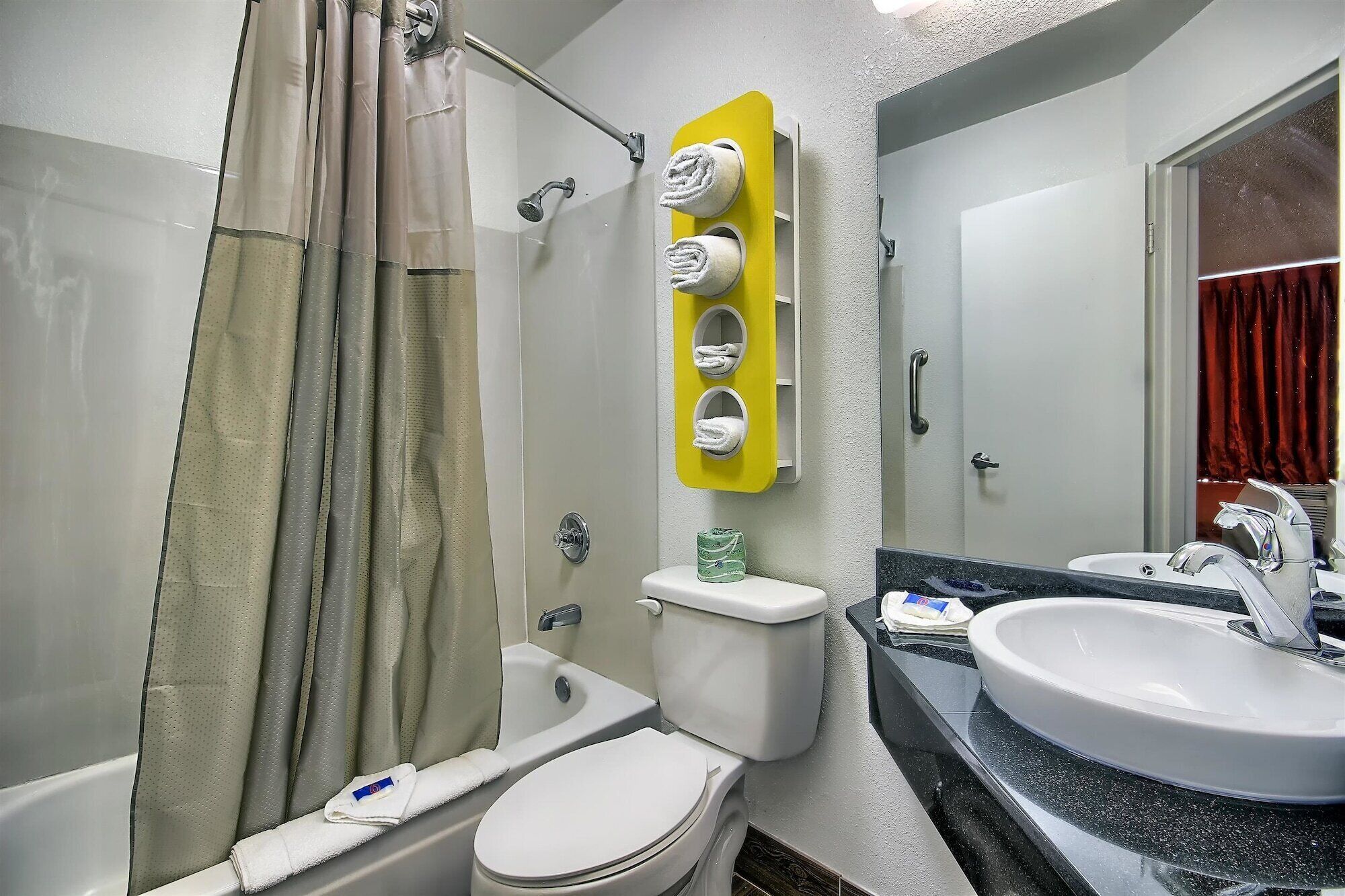 A bathroom with a bathtub, toilet, and sink.