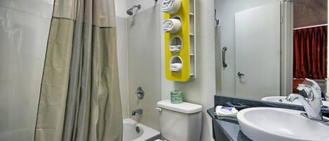 A bathroom with a bathtub, toilet, and sink.