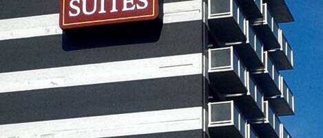 Um edifício com a placa da Comfort Suites. Possui vários andares com varandas.