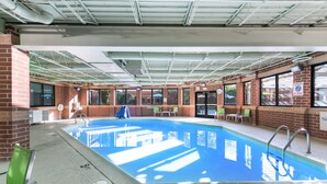 An indoor swimming pool with clear blue water, surrounded by brick walls and large windows. - Holiday Inn Express Naperville by IHG (Naperville)