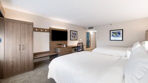 A hotel room with a large bed, a desk with a chair, a wardrobe, and two framed pictures on the wall. - Holiday Inn Express Naperville by IHG (Naperville)