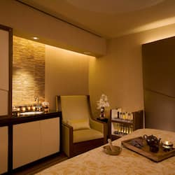 Relax in a cozy space with a comfortable bed, seating area, and ample storage.