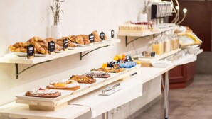 A buffet with various pastries and desserts.