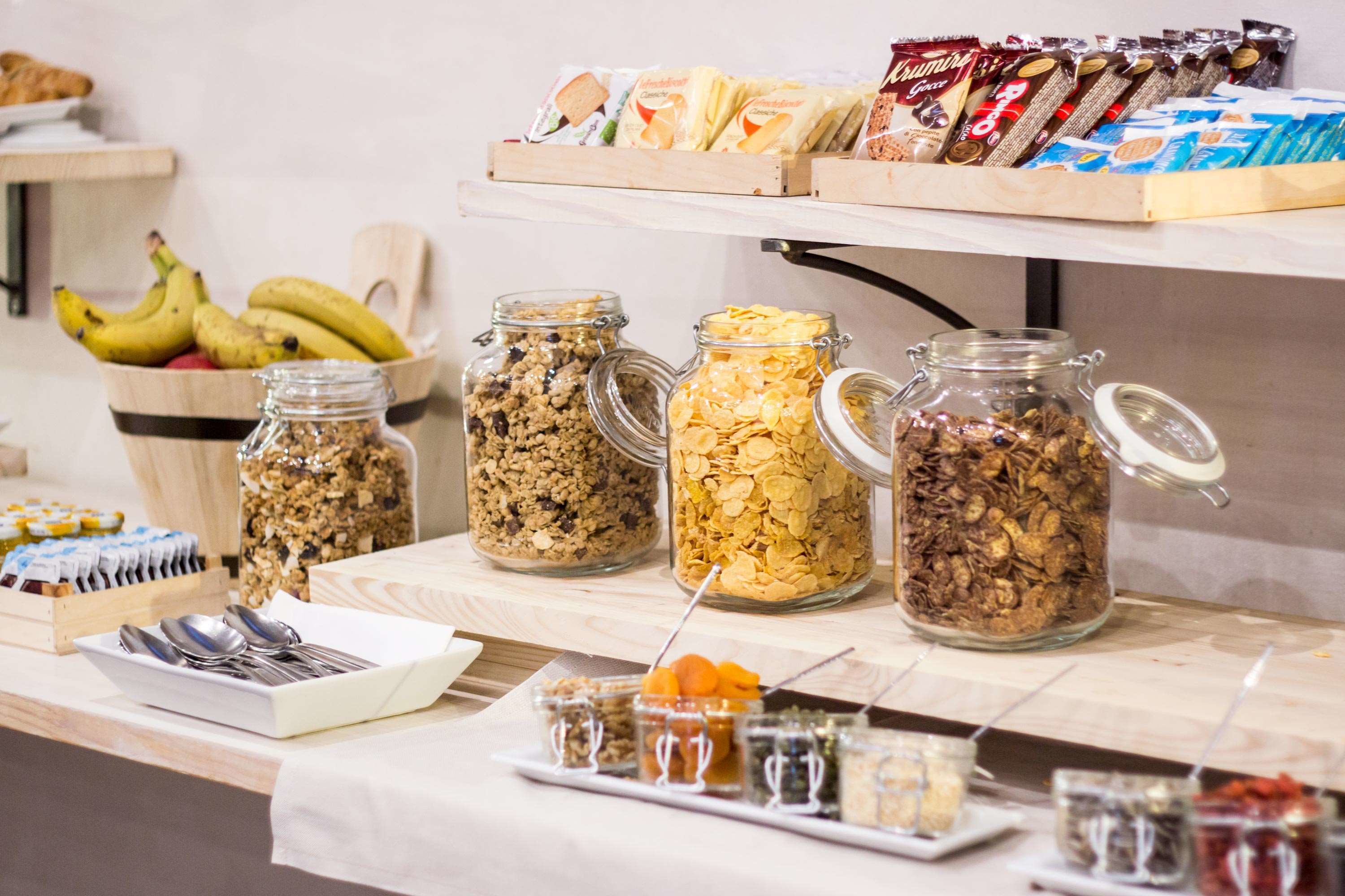 Un buffet de petit-déjeuner proposant une variété d’aliments, notamment des céréales, des fruits et des en-cas emballés.