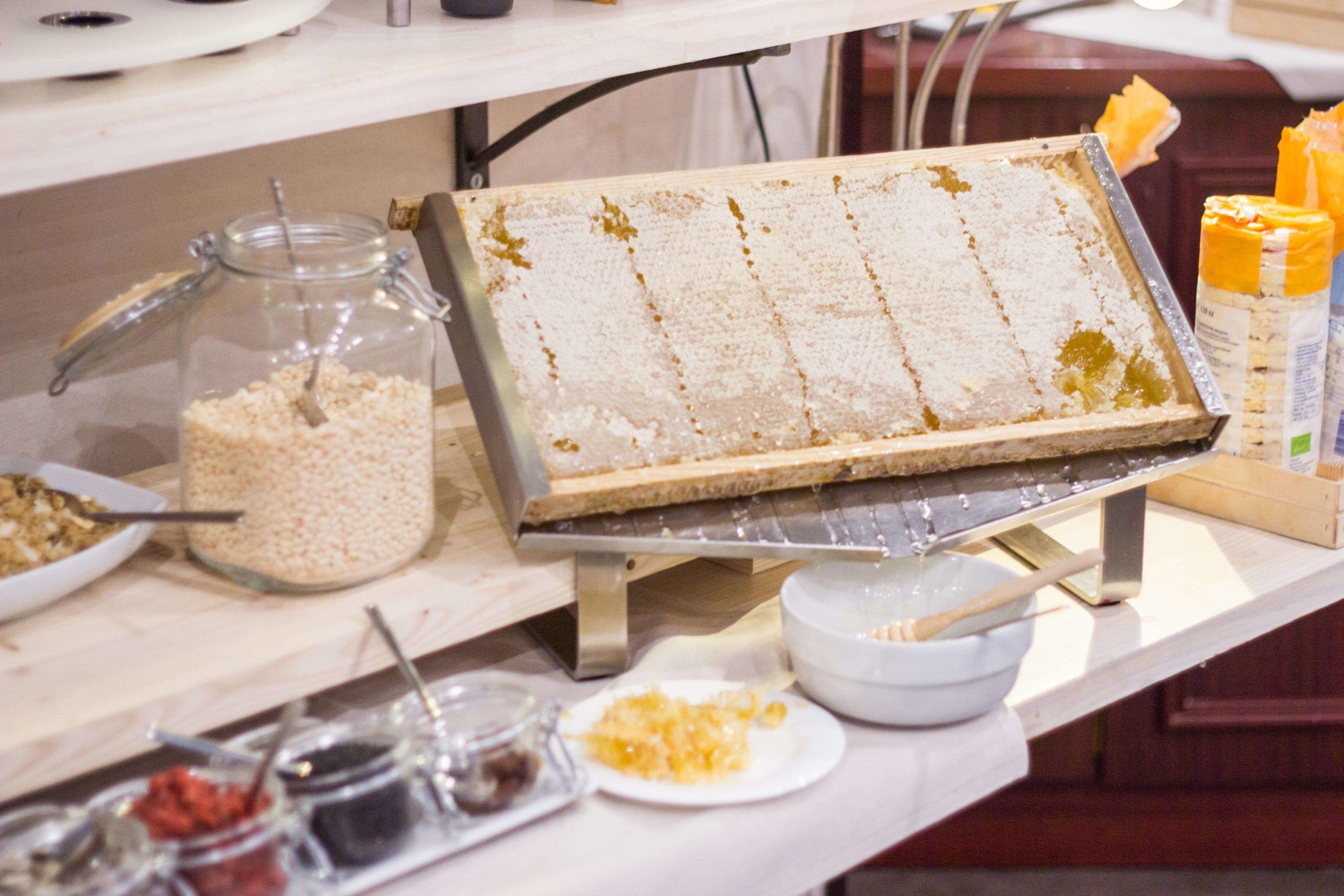A buffet setup with a variety of food items and condiments.