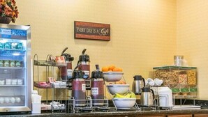 A hotel breakfast area with a coffee station, fruit bowl, cereal, and a sign that says "Every day is a gift." - Howard Johnson by Wyndham Brigham City (Brigham City)