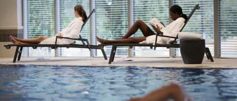 Una piscina cubierta, una piscina al aire libre de temporada, tumbonas