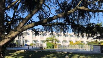 A building with a modern architectural style, featuring a symmetrical facade with multiple windows and balconies.