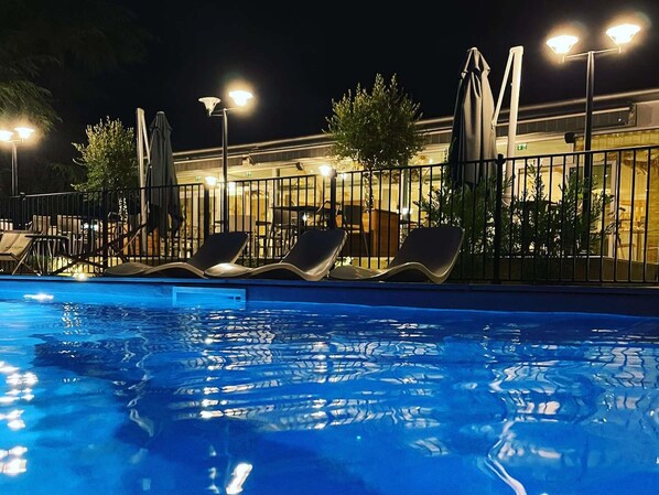Seasonal outdoor pool, open 9:00 AM to 9:00 PM, pool umbrellas