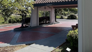 A Travelodge sign, a covered entrance, and a paved walkway.