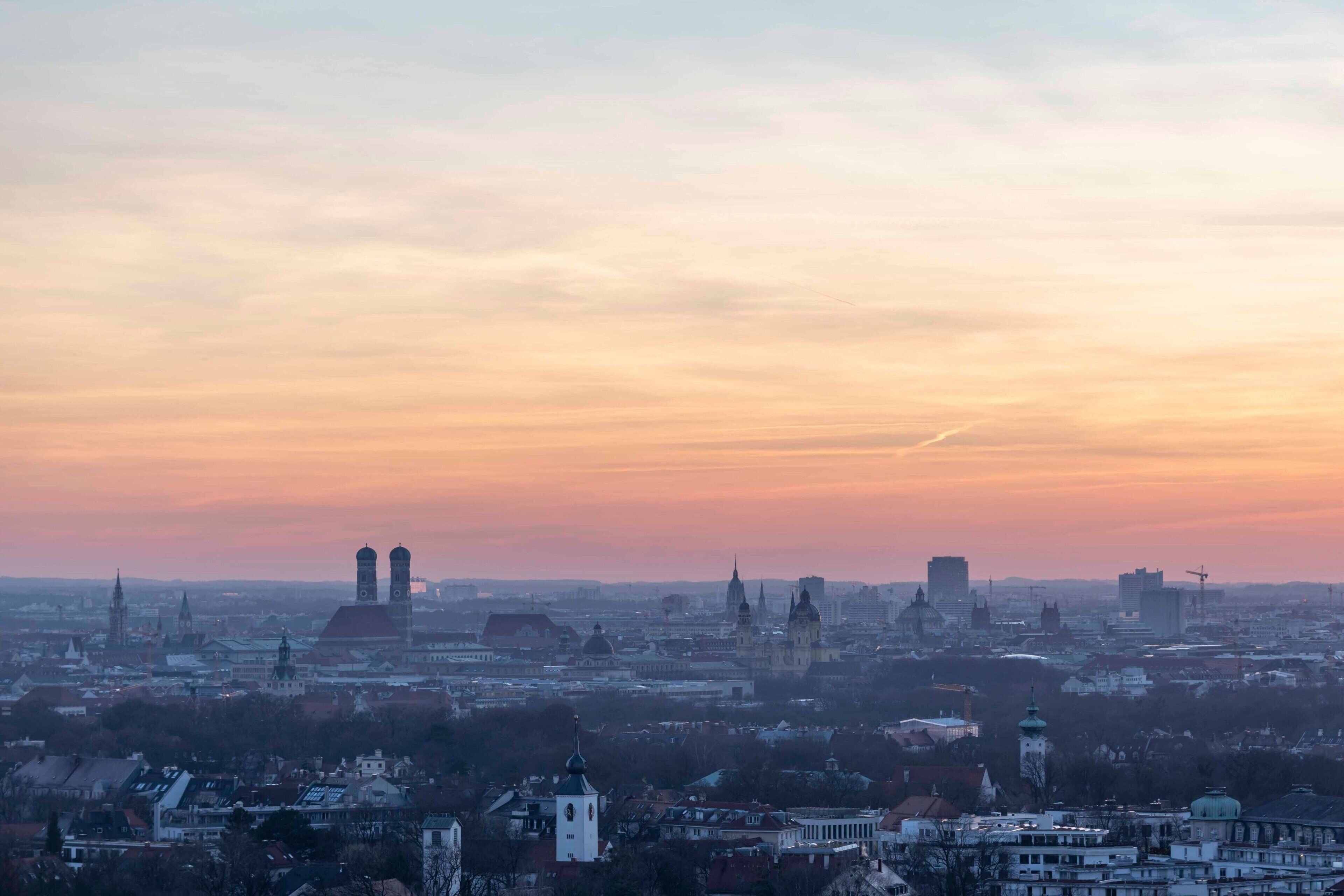 A cityscape with prominent historical buildings and a clear sky at dusk.