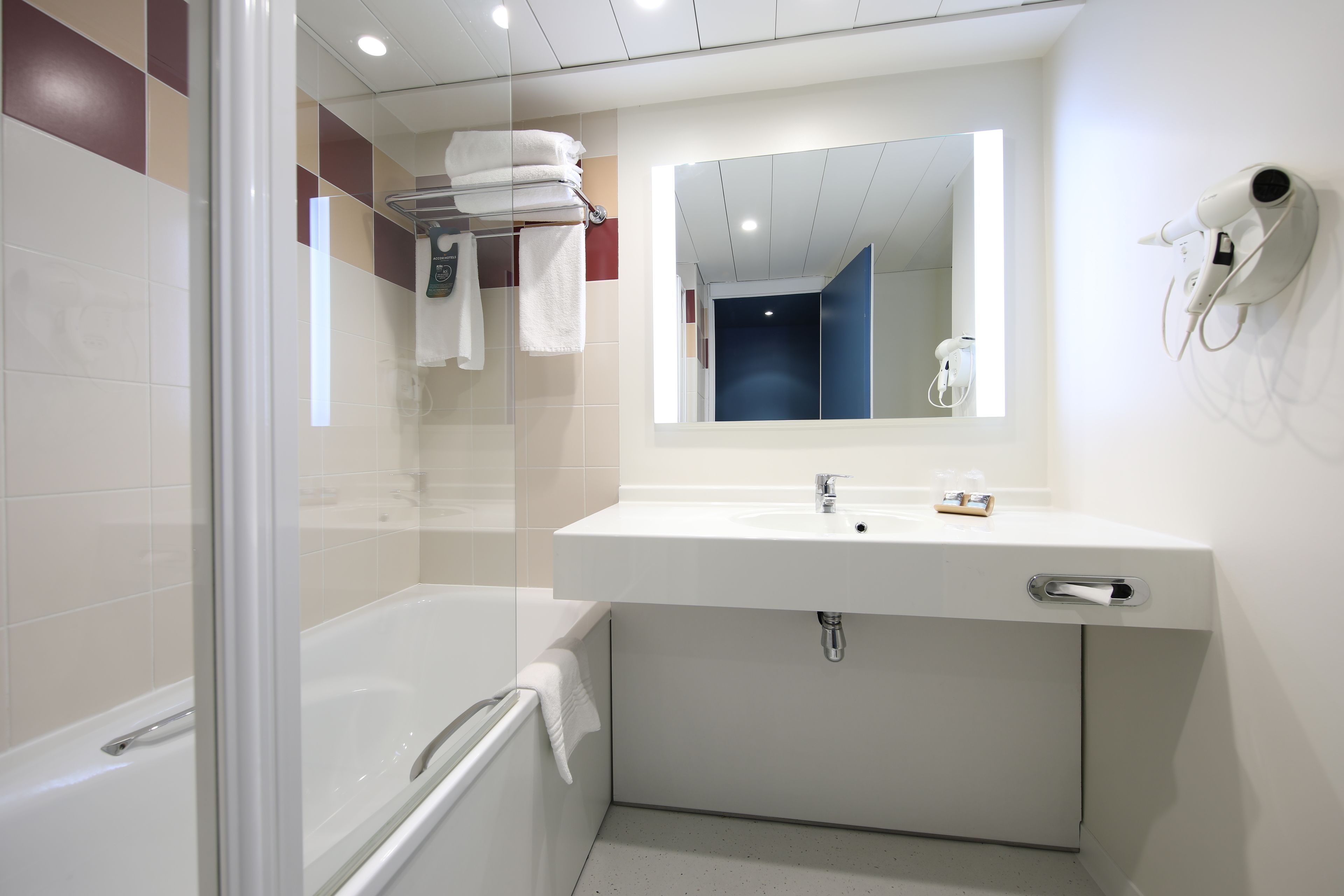 bathtub, eco-friendly toiletries, hair dryer, towels