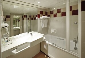 Bathtub, eco-friendly toiletries, hair dryer, towels