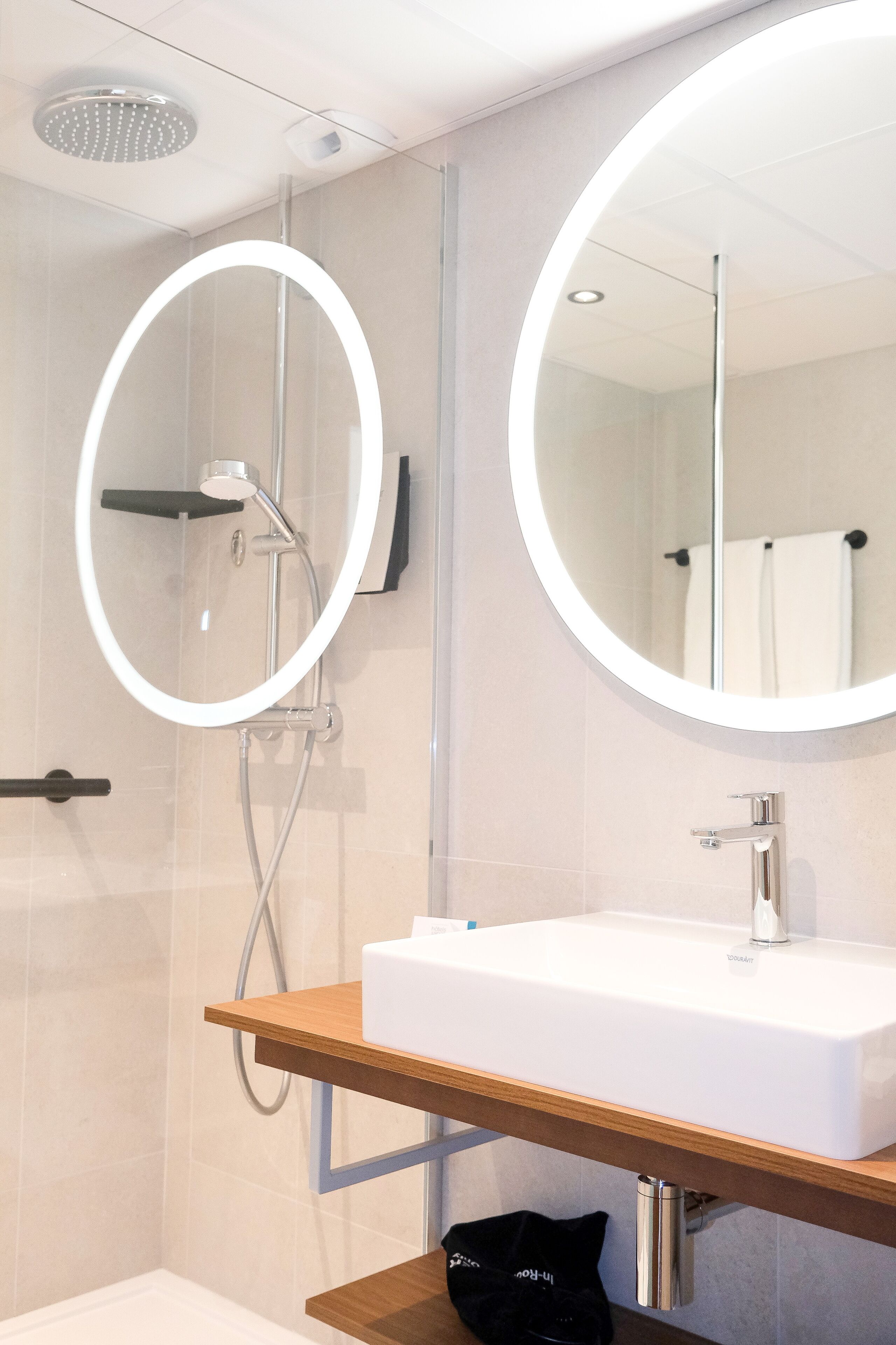 shower, hair dryer, slippers, towels