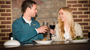 A man and a woman sitting at a table with plates of food and glasses of drinks. - Heritage Hotel Lancaster (Lancaster)