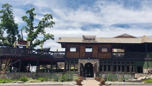 A two-story building with a stone facade, wooden balconies, and a sign reading "OXYLES." - Heritage Hotel Lancaster (Lancaster)