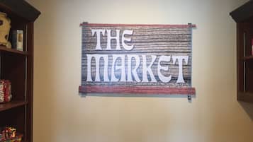 A wall with a sign that reads "THE MARKET".