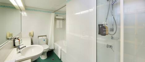 A bathroom with a sink, toilet, and shower.