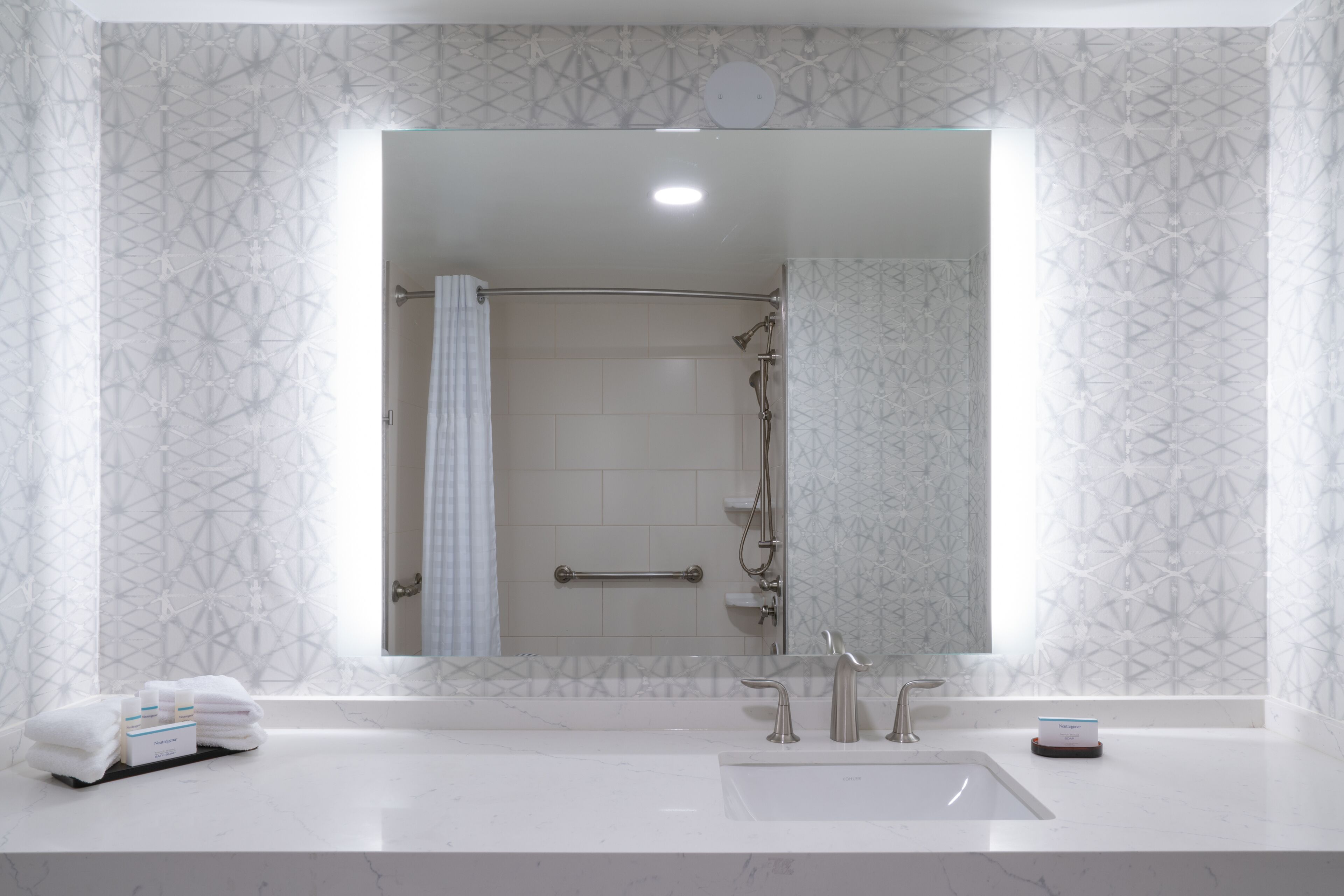 designer toiletries, hair dryer, towels, soap