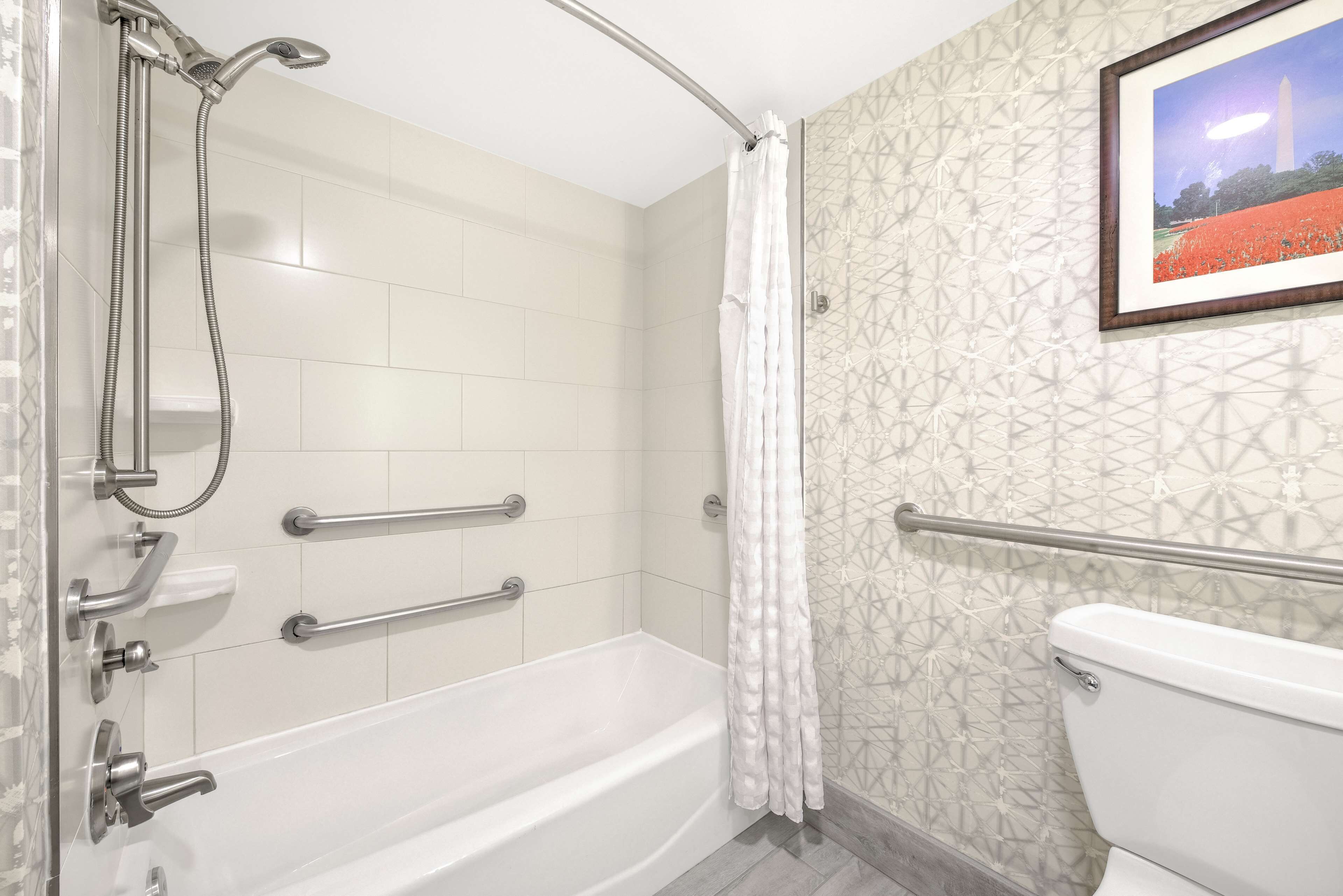 A bathroom with a bathtub, a shower, and a toilet.