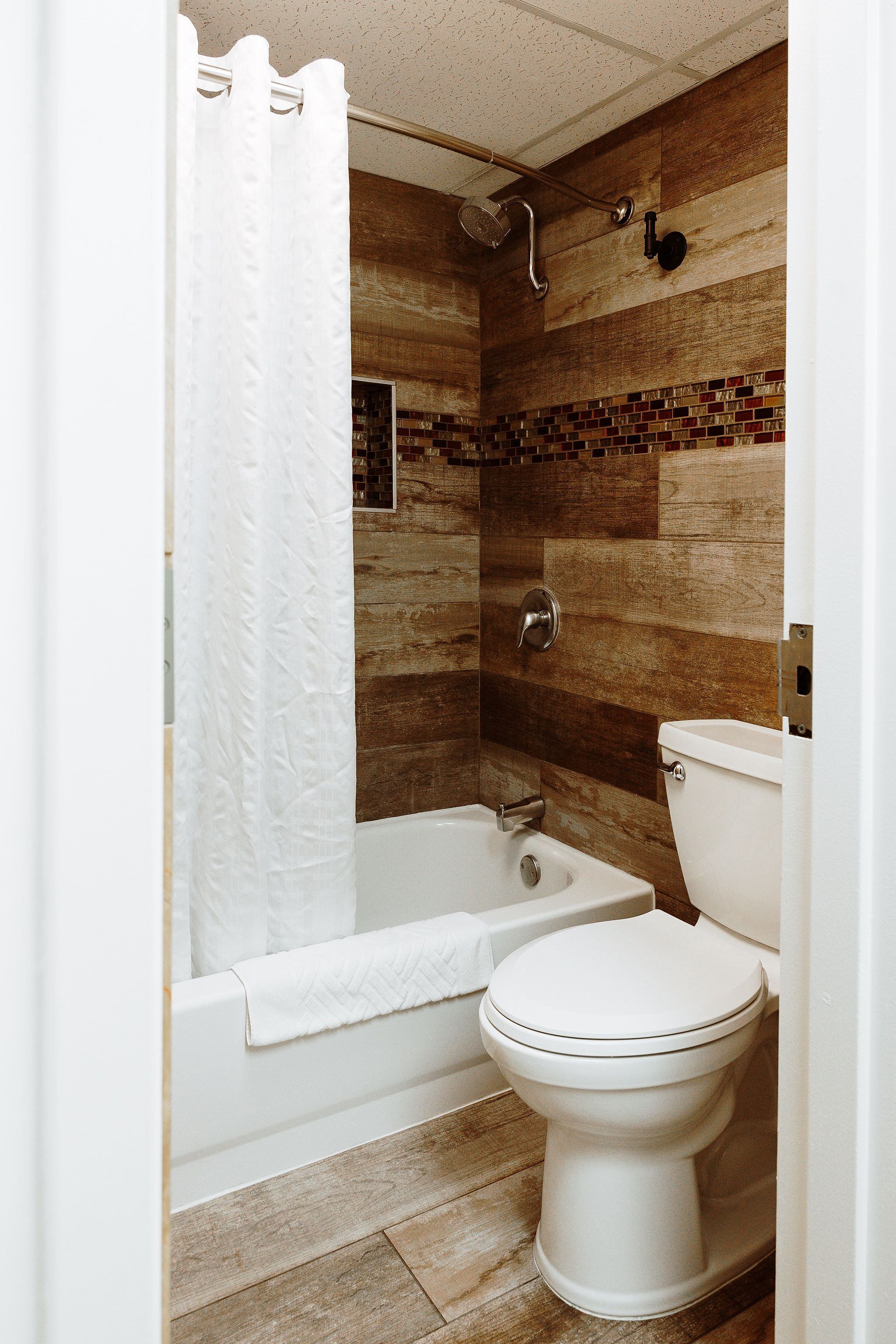 A bathroom with a bathtub, toilet, and shower.