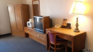 A hotel room with a wooden desk, a television, a telephone, a lamp, and a wardrobe. - State Line Inn (Hagerstown)