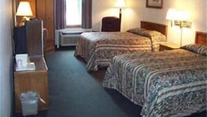 A hotel room with two beds, a desk, a chair, a TV, and a window with curtains. - State Line Inn (Hagerstown)