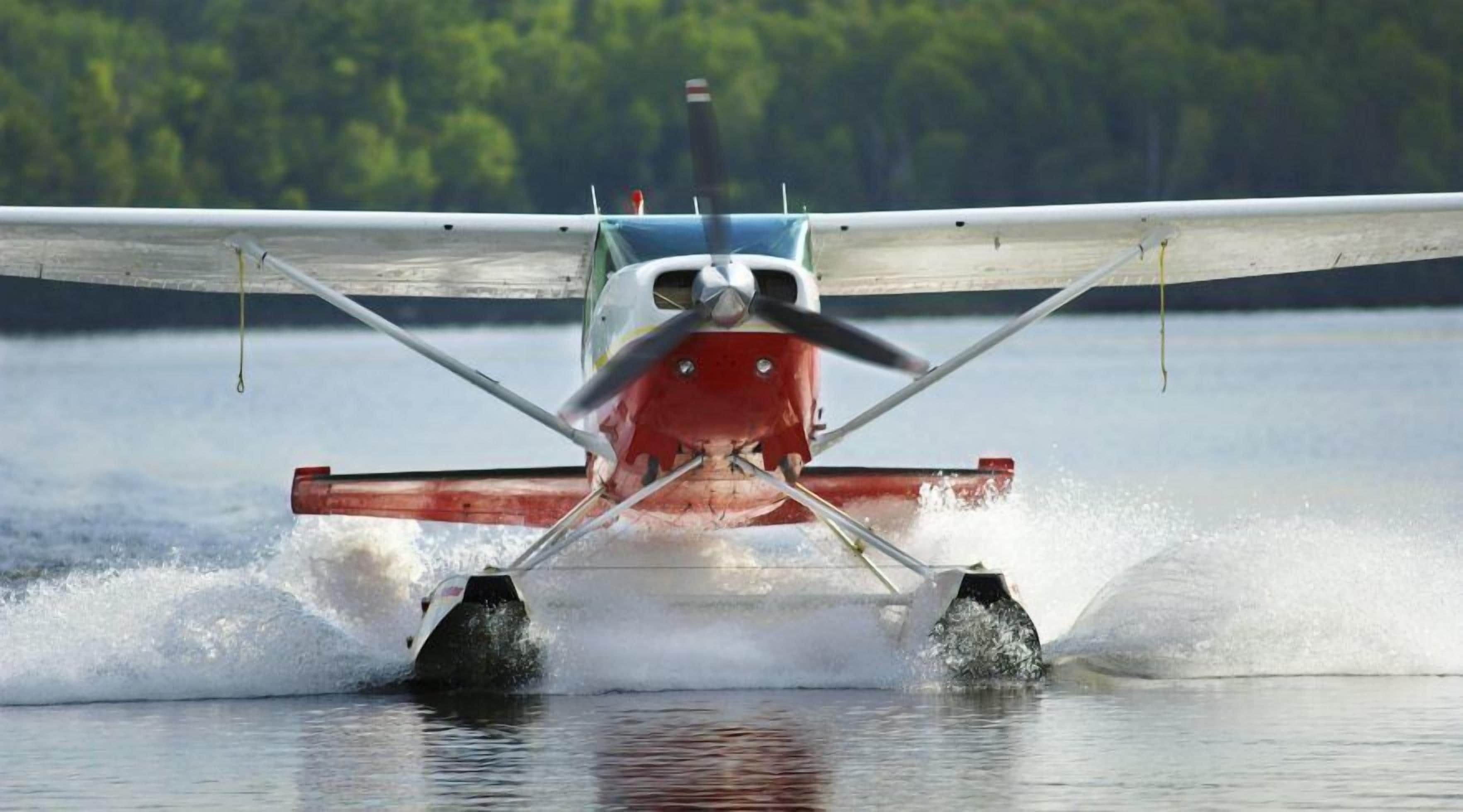 An airplane taking off from a water runway.