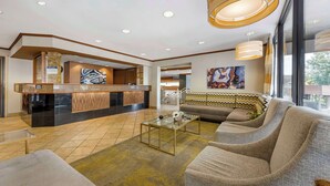 A hotel lobby with a reception desk, seating area, and large windows. - Best Western Plus Landing View Inn & Suites (Branson)