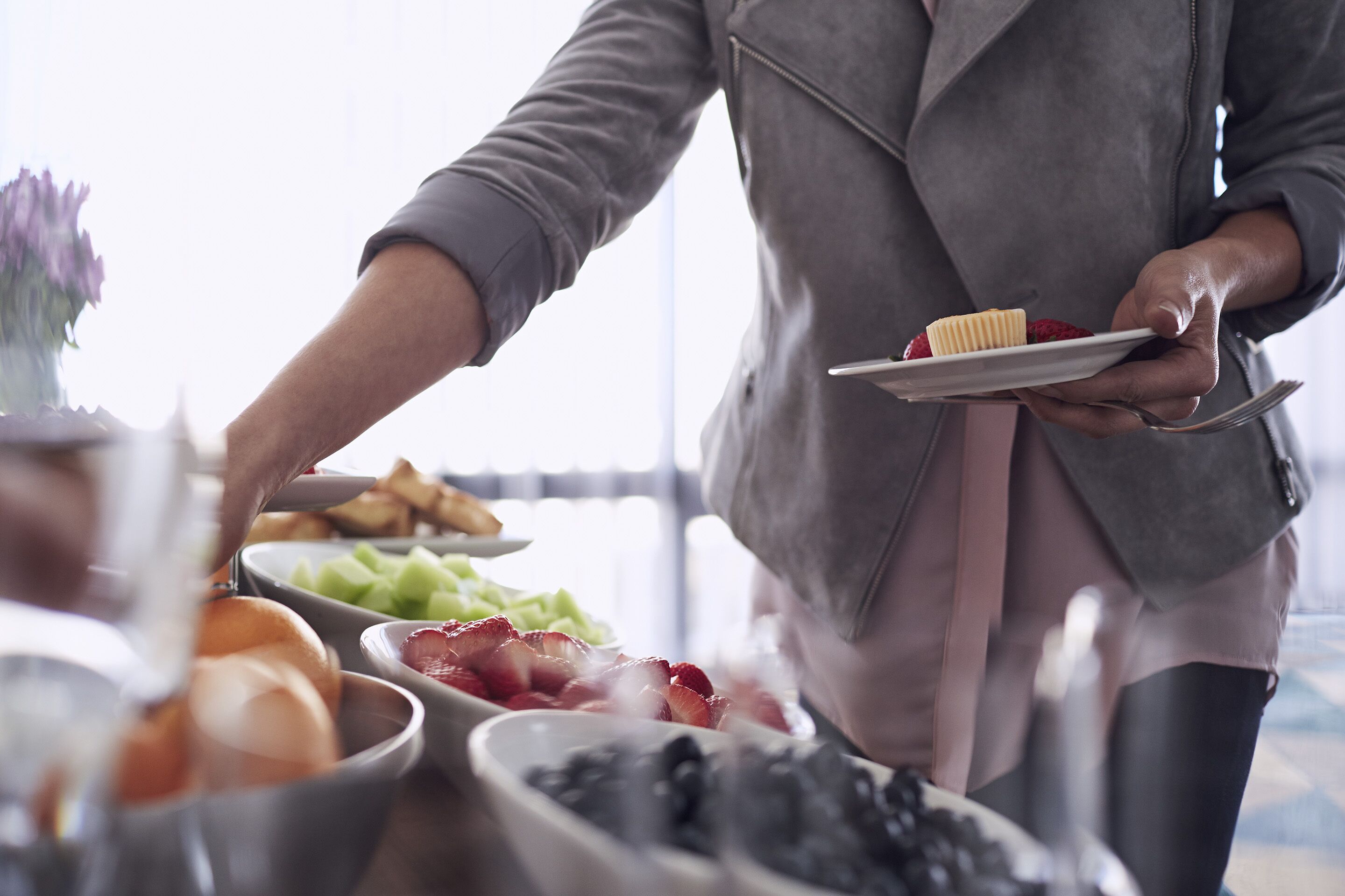 A person serving food from a bowl.