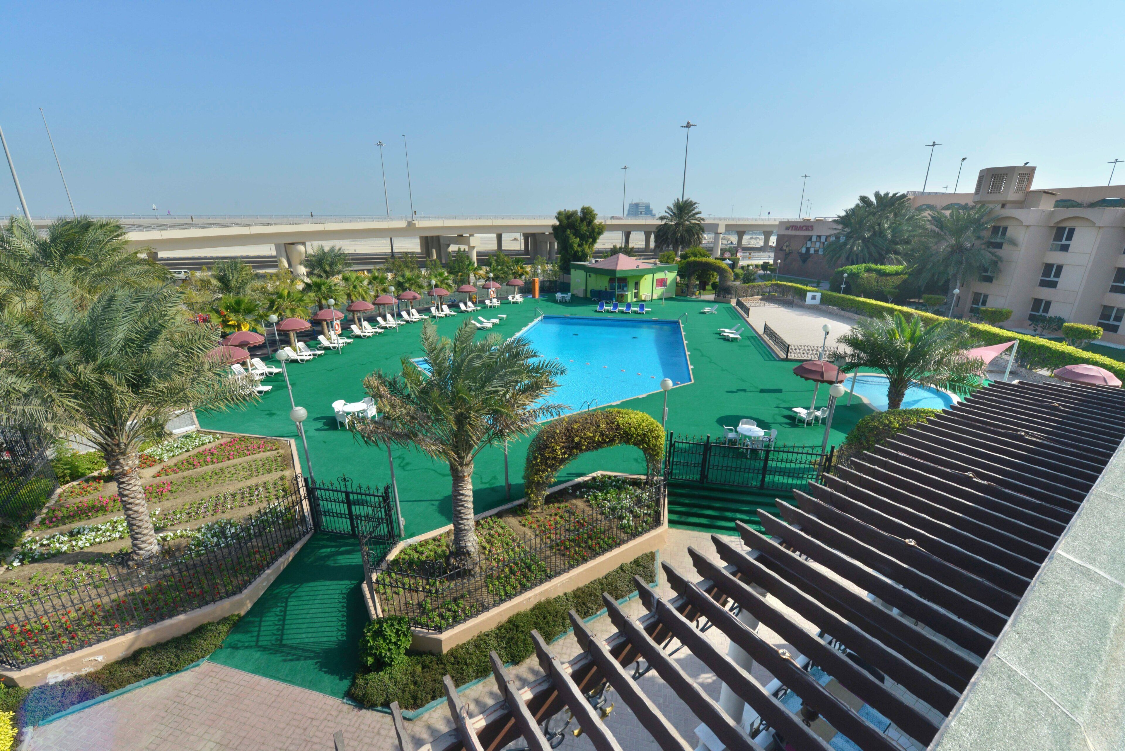 A rooftop pool area with sun loungers and a swimming pool.