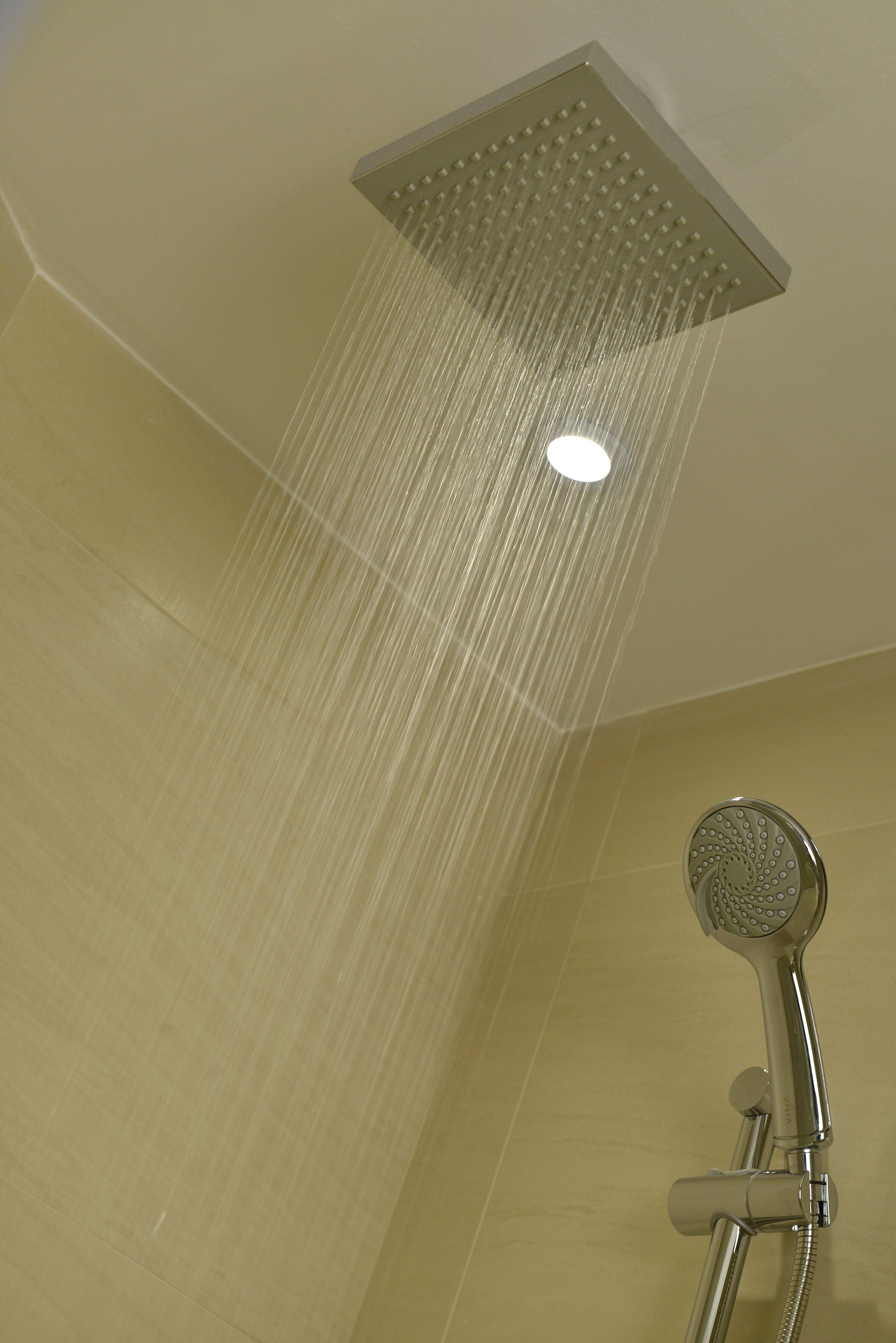 A showerhead with water flowing down.