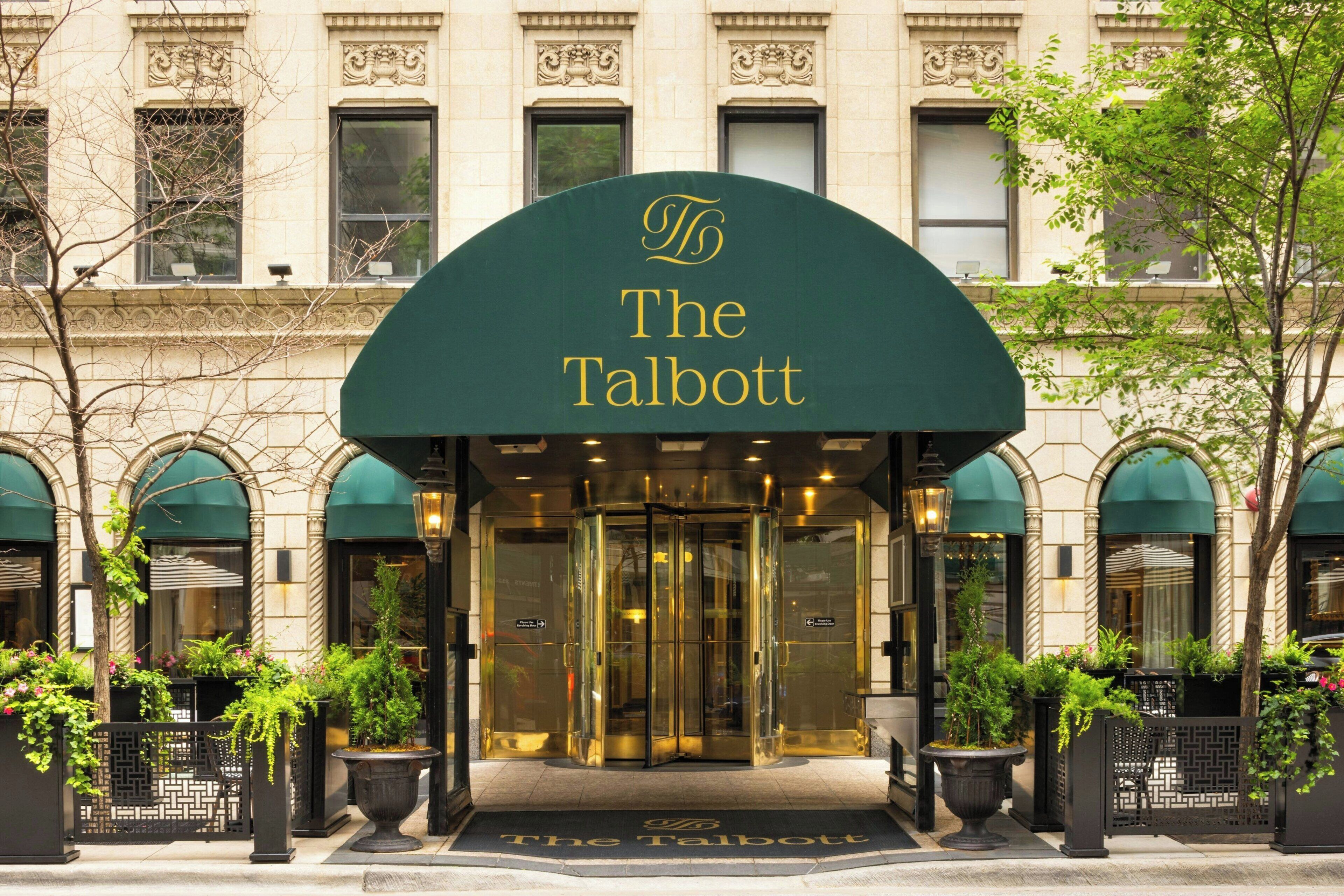 A hotel entrance with a green awning displaying the name "The Talbott".