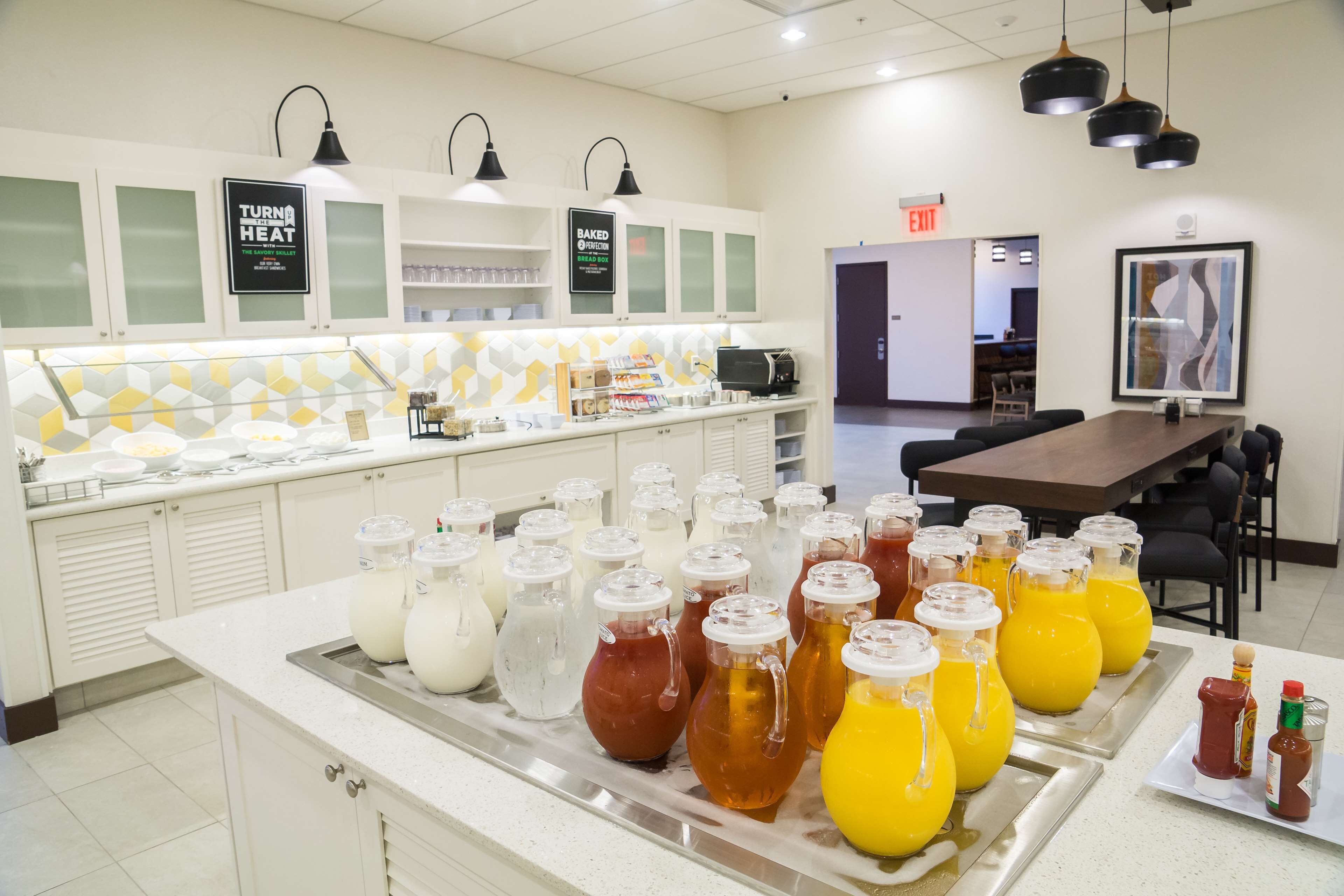 A breakfast bar with various beverages and condiments.