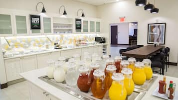 A breakfast bar with various beverages and condiments.