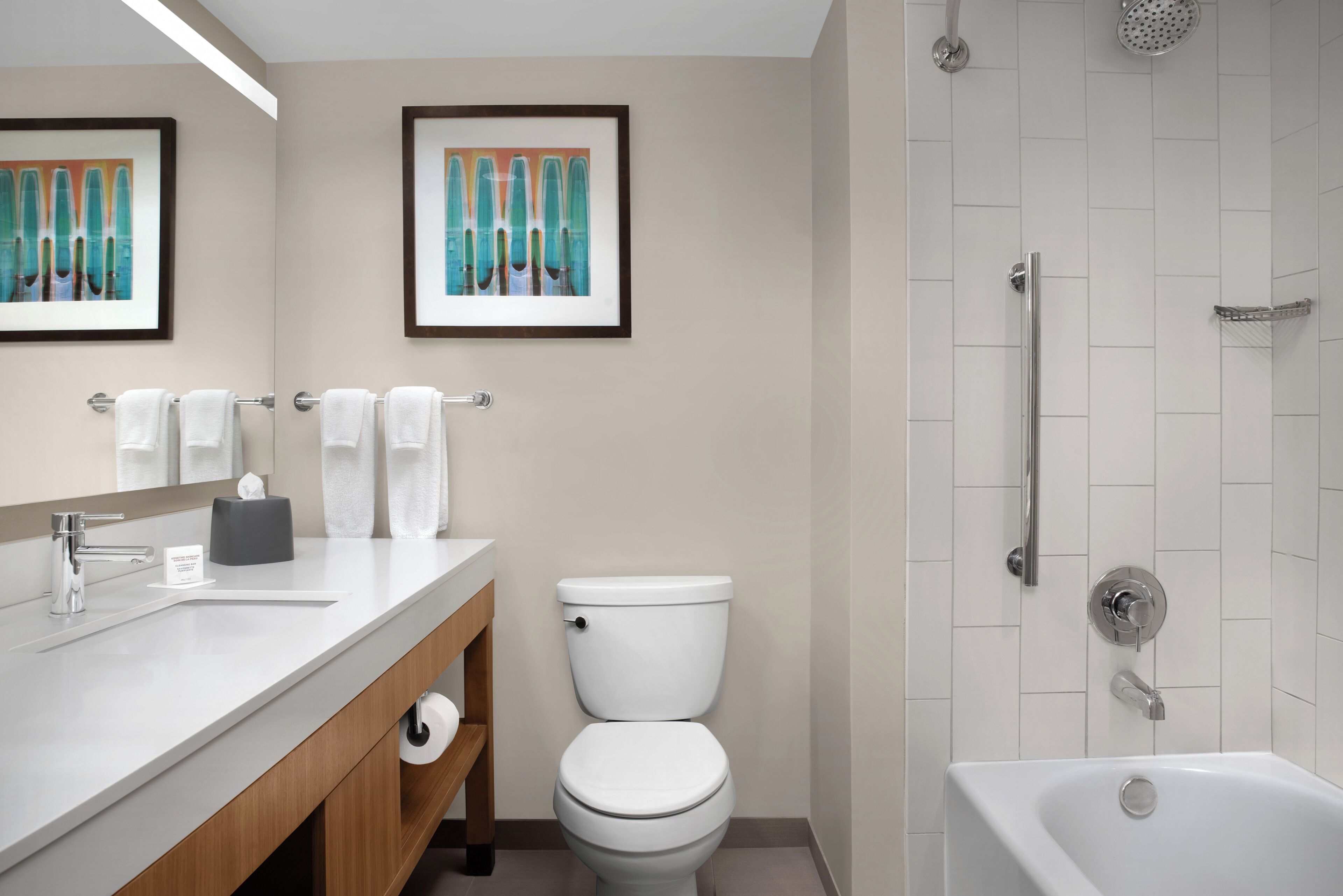 A modern bathroom with a toilet, sink, and shower.