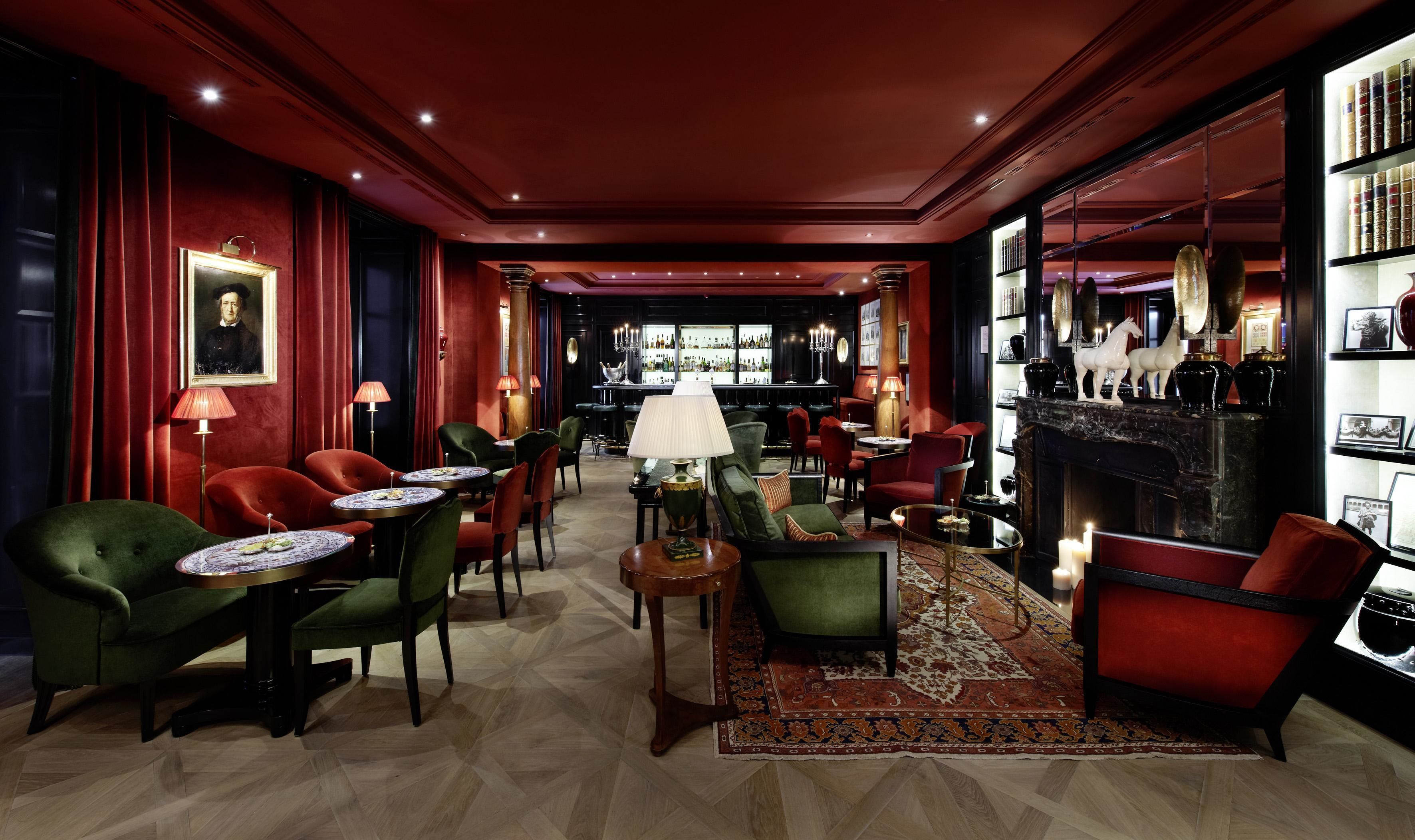 Un salon luxueux doté de sièges confortables, d’un bar et d’une cheminée.