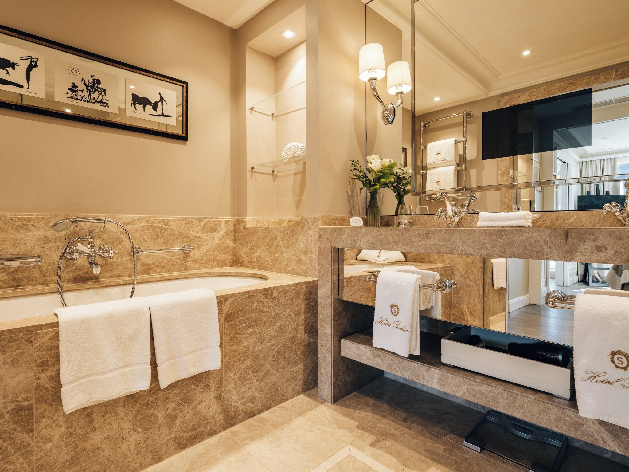 A modern bathroom with a large bathtub, a separate shower area, and a vanity with a mirror.
