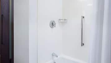 A modern bathroom with a walk-in shower, a bathtub, and a toilet.
