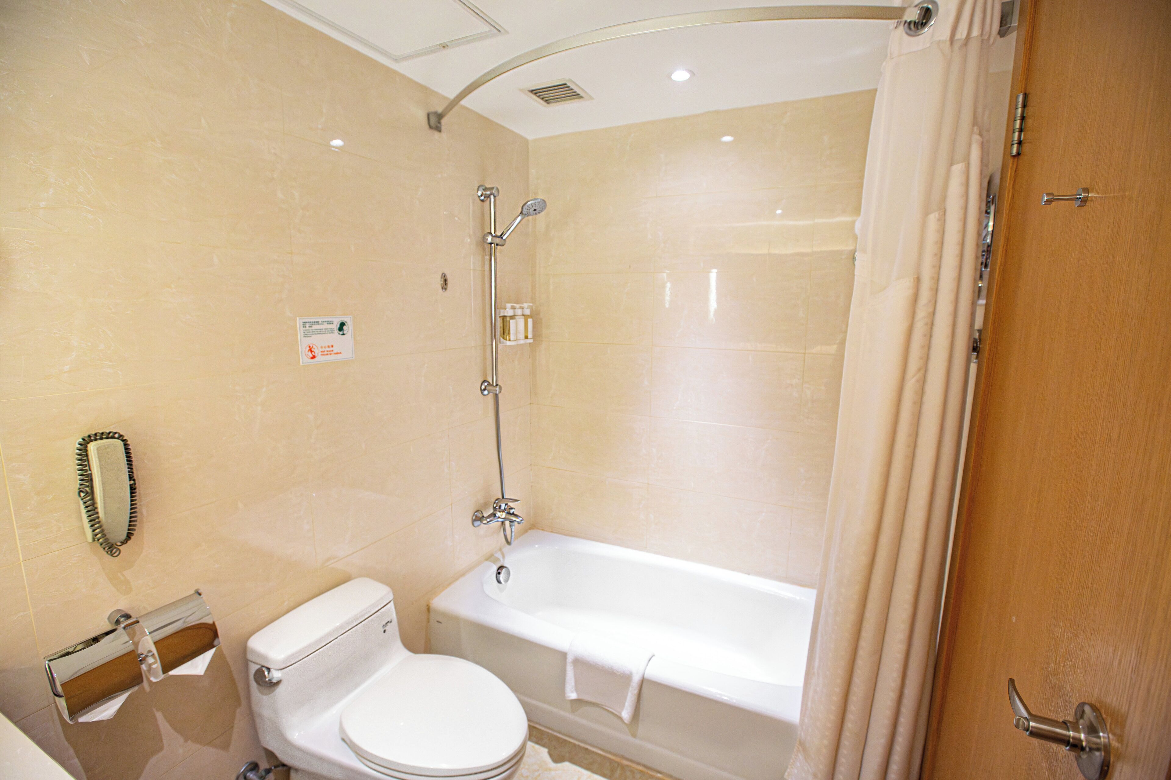 A bathroom with a toilet, a bathtub, and a shower.
