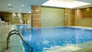 An indoor swimming pool with clear blue water, surrounded by wooden walls and a tiled floor. - Holiday Inn Macau by IHG (Macau)