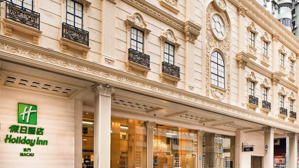 A Holiday Inn hotel facade with classical architecture, large windows, and a prominent entrance. - Holiday Inn Macau by IHG (Macau)