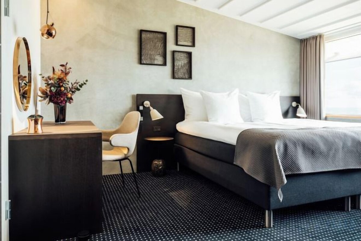 Premium bedding, desk, laptop workspace, blackout curtains
