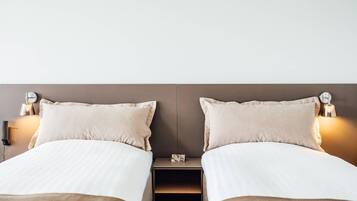 Premium bedding, desk, laptop workspace, blackout drapes