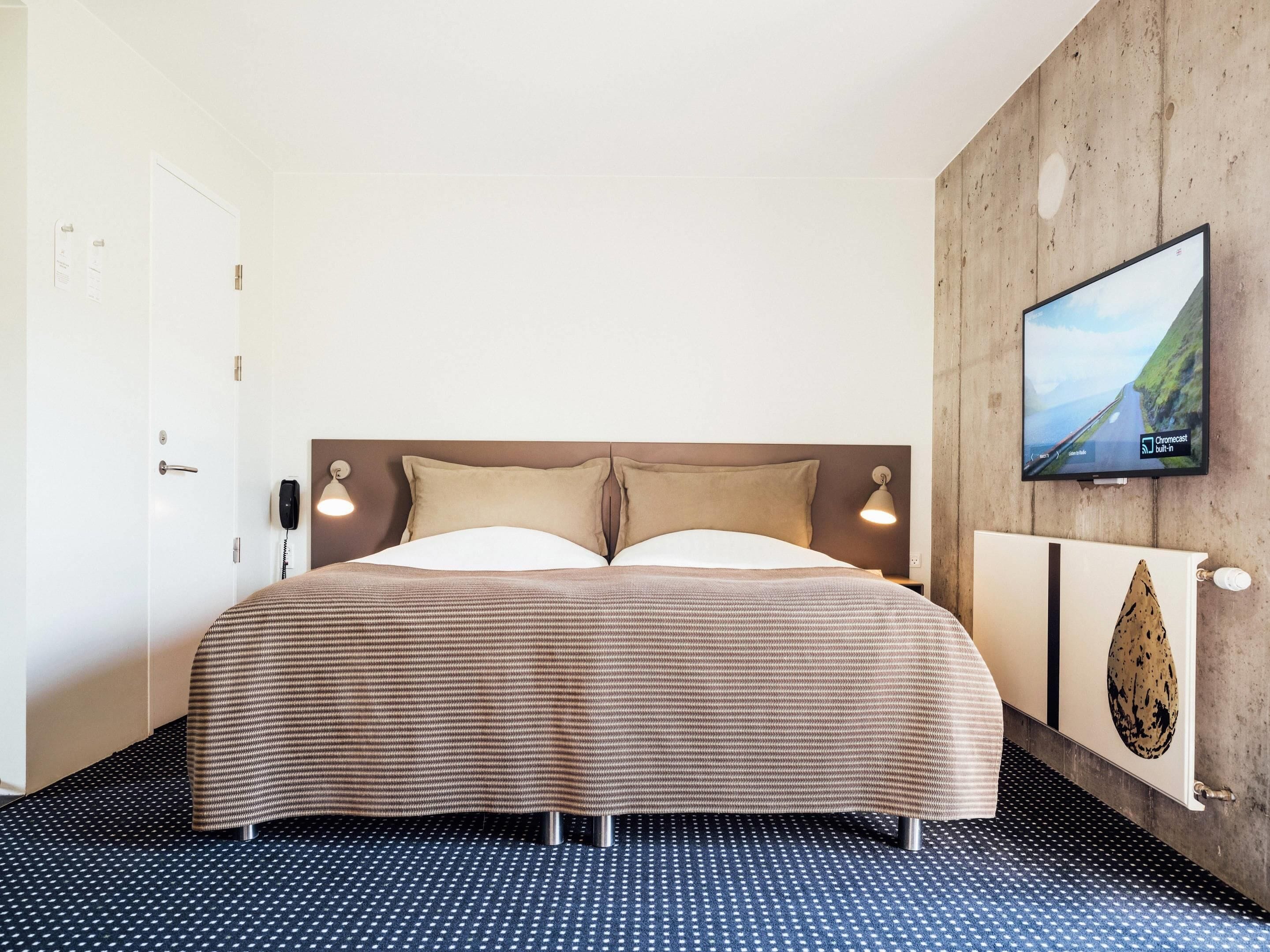 Premium bedding, desk, laptop workspace, blackout drapes