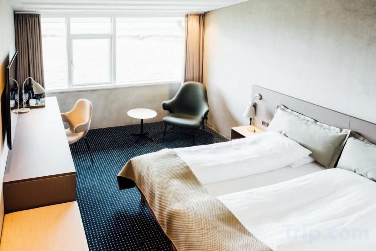 Premium bedding, desk, laptop workspace, blackout drapes