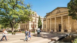 A public square with a classical building labeled 'The Art Gallery of South Australia,' featuring a fountain and pedestrian pathways.