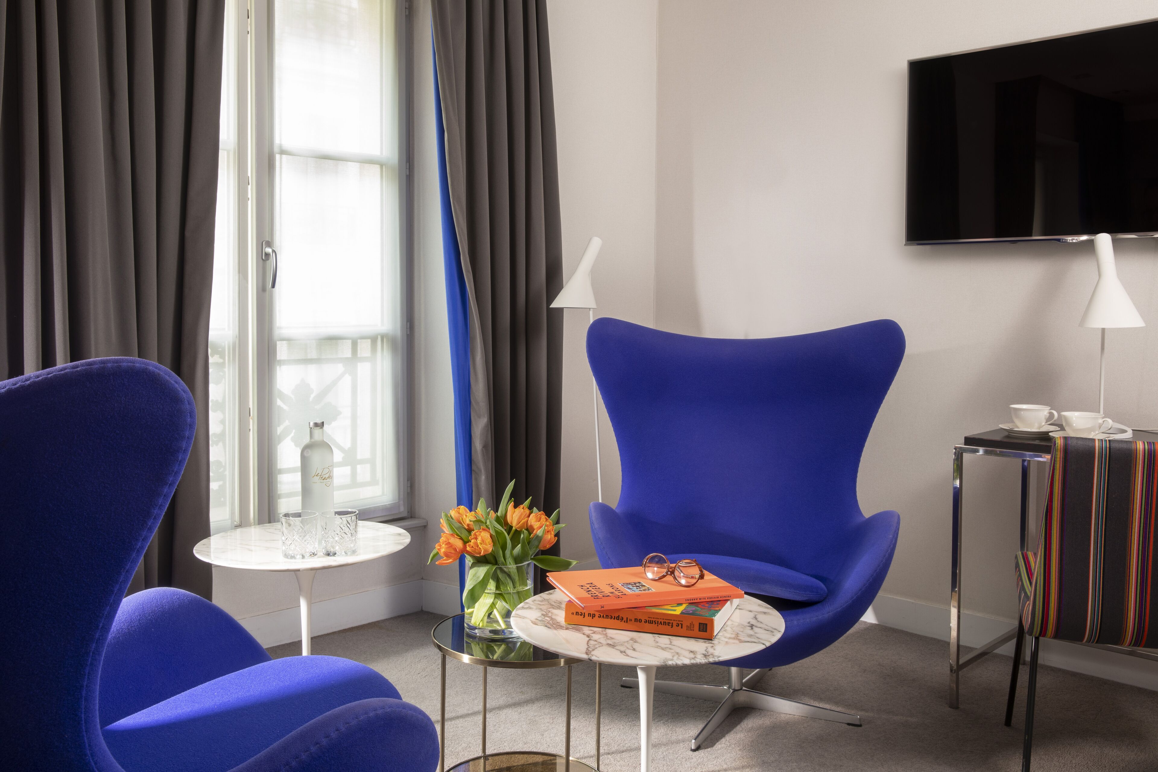 deluxe suite (parisienne) | living area | 82-inch flat-screen tv with satellite channels, tv
